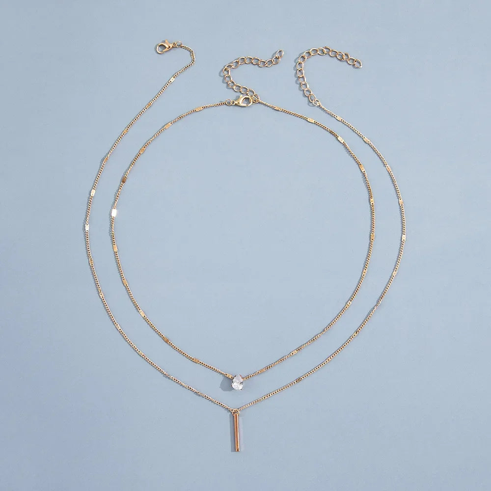 An eye catching Multi-layer Necklace with a Simple Crystal Water Drop in Gold or Silver Color