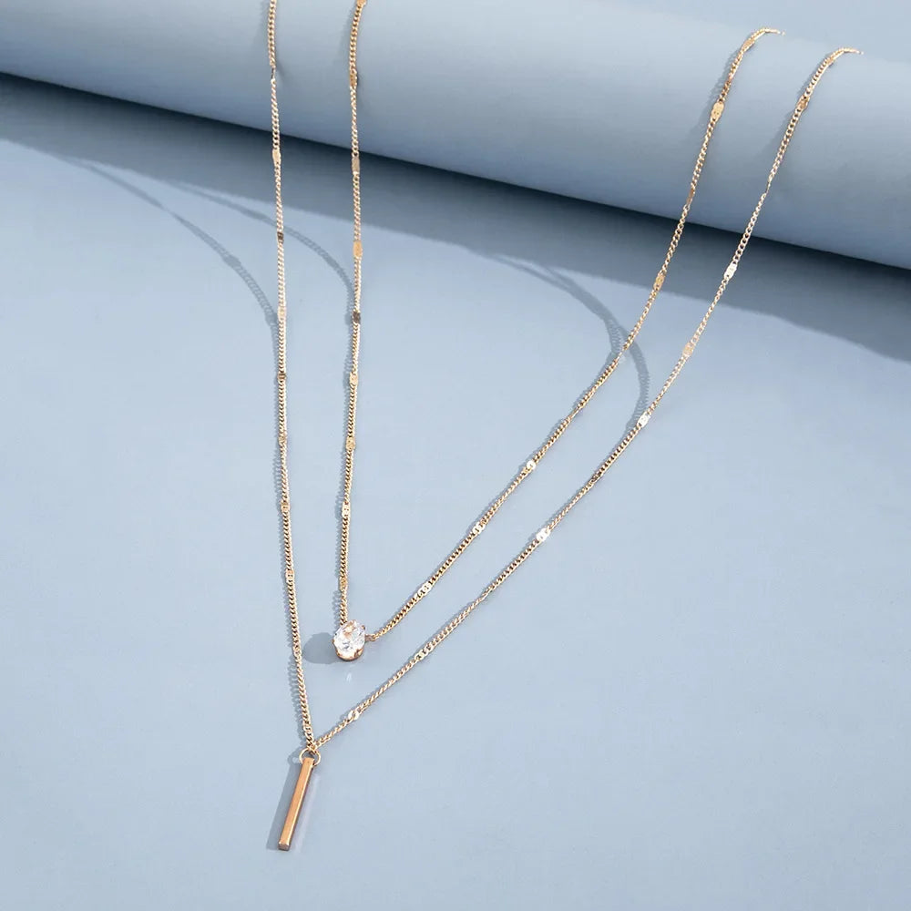 An eye catching Multi-layer Necklace with a Simple Crystal Water Drop in Gold or Silver Color