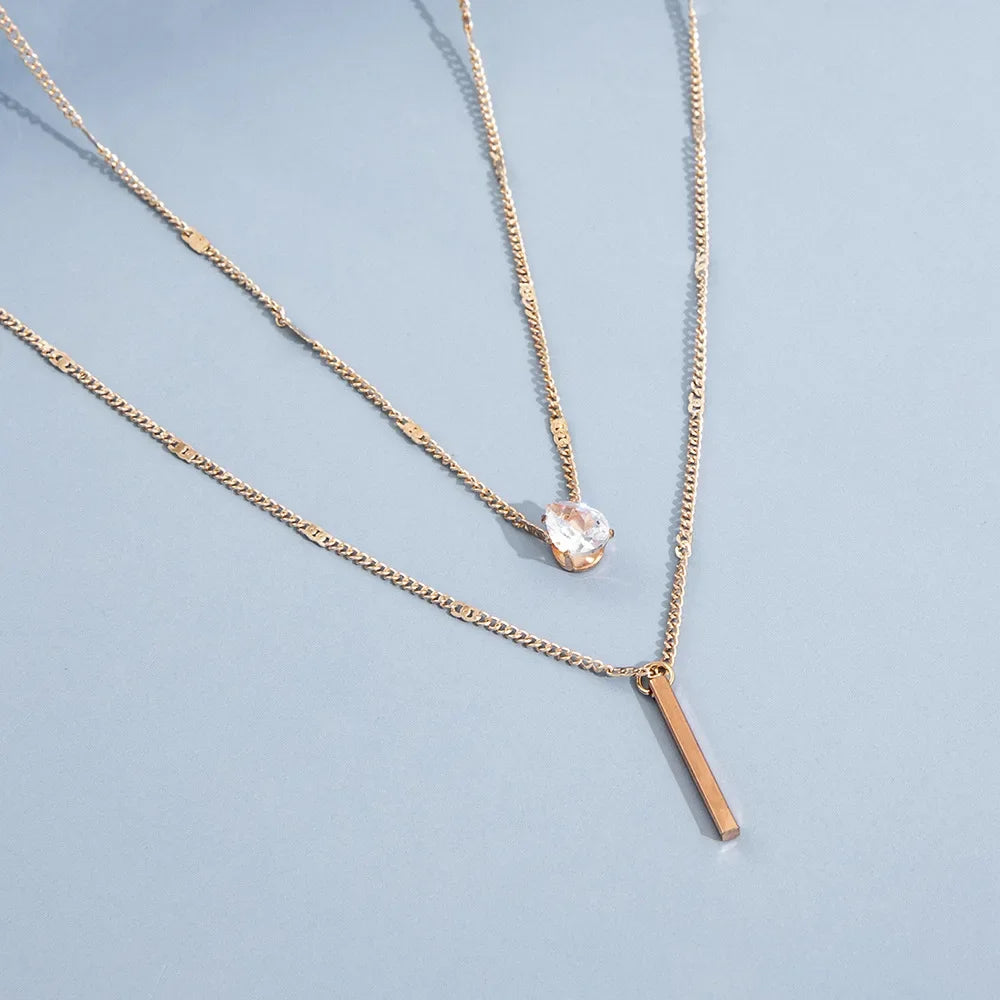 An eye catching Multi-layer Necklace with a Simple Crystal Water Drop in Gold or Silver Color