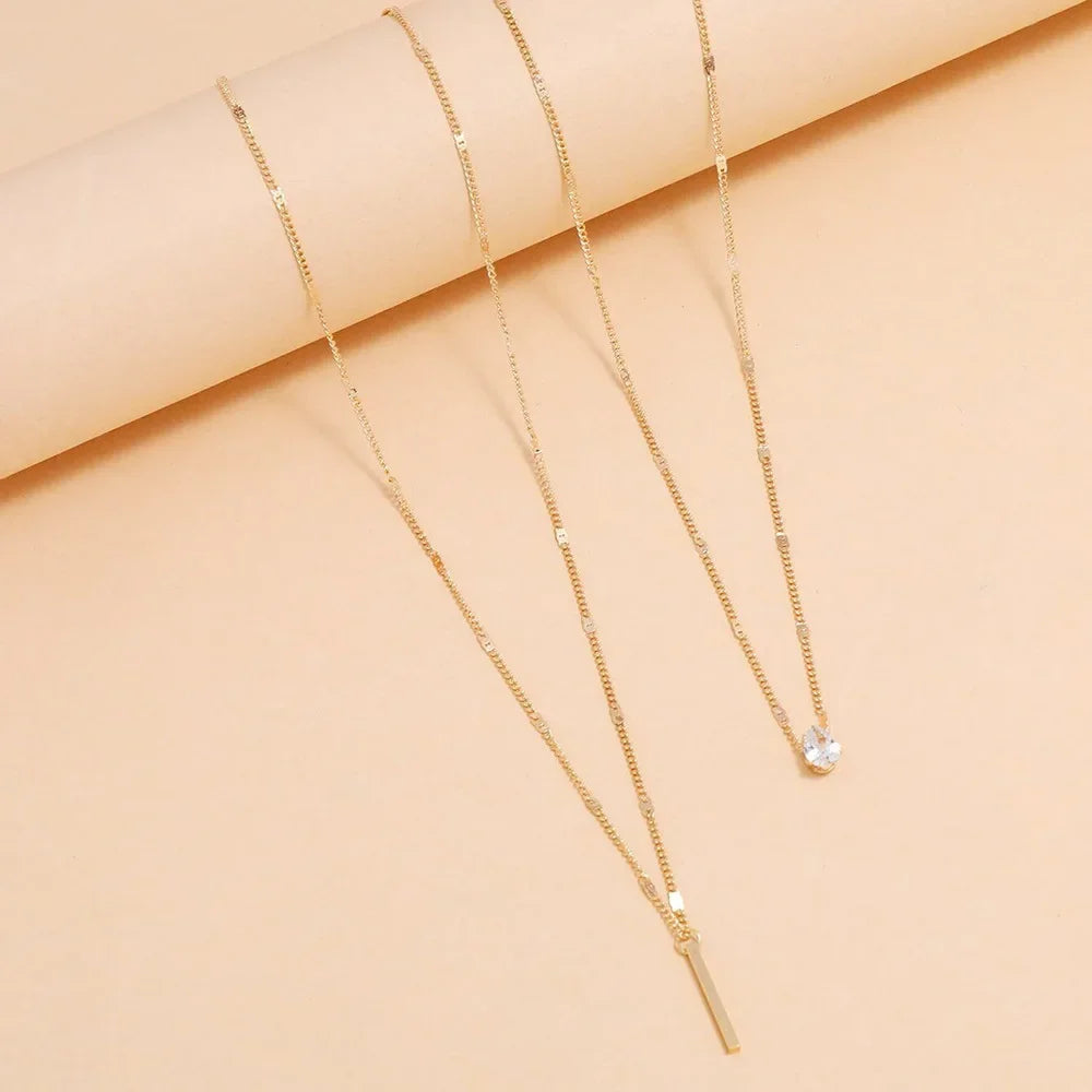 An eye catching Multi-layer Necklace with a Simple Crystal Water Drop in Gold or Silver Color