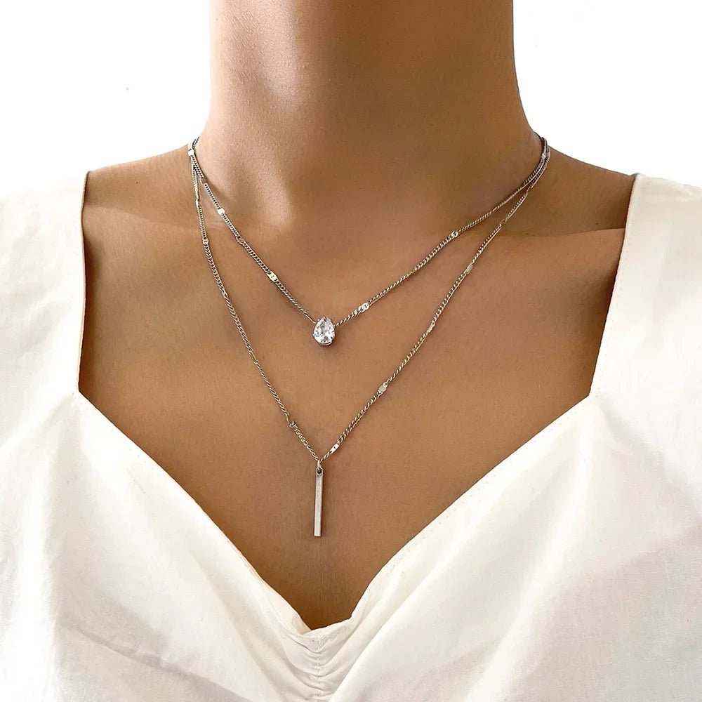 An eye catching Multi-layer Necklace with a Simple Crystal Water Drop in Gold or Silver Color