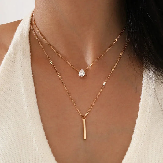 An eye catching Multi-layer Necklace with a Simple Crystal Water Drop in Gold or Silver Color